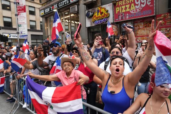 Revelers dressed in Dominican flag colors. 