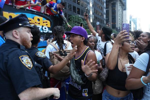 Members of the New York City Police Department perform crowd co<em></em>ntrol as spectators overflowed o<em></em>nto the path of the parade during the Natio<em></em>nal Dominican Day Parade on Sunday, August 11, 2024 in New York, N.Y. (