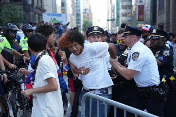 Members of the New York City Police Department arrested a man as spectators overflowed o<em></em>nto the path of the parade during the Natio<em></em>nal Dominican Day Parade on Sunday, August 11, 2024 in New York, N.Y. 