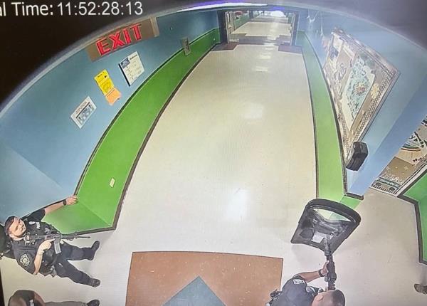 Officers are seen with rifles, a ballistic shield 9 minutes after the gunman entered the elementary school.