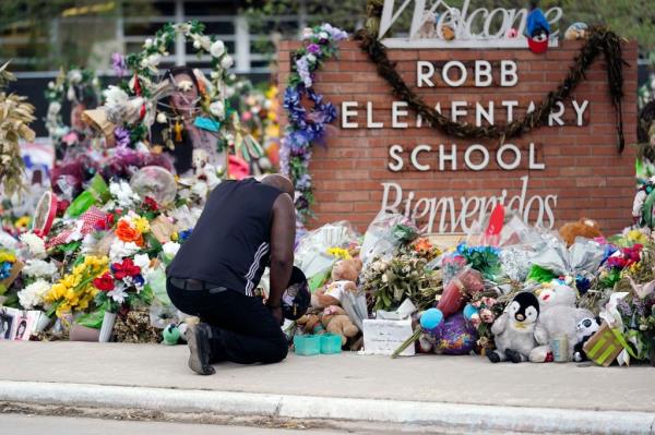 Reggie Daniels pays his respects a memorial at Robb Elementary School, Thursday, June 9, 2022