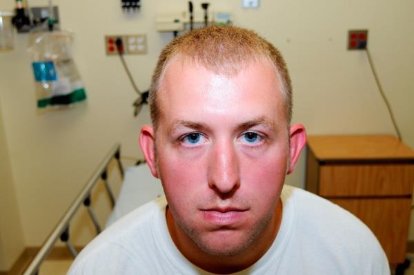 Then Ferguson Police Officers Darren Wilson pictured during a medical examination after fatally shooting Brown.