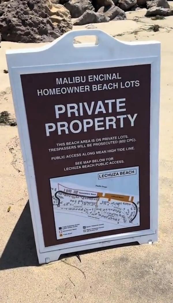 A picture of the sign claiming the beach area is private.