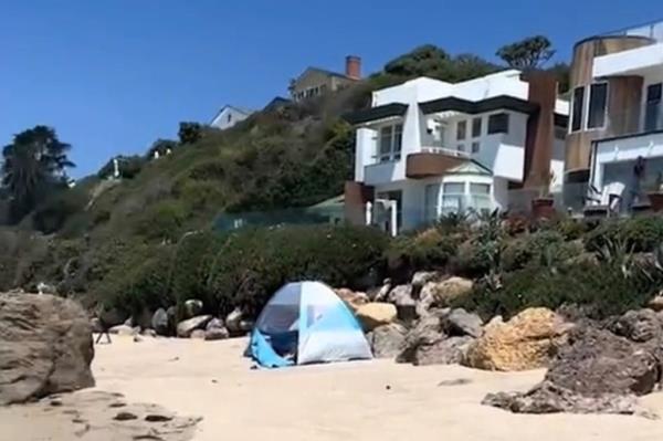 A still image from the video shows the palatial mansions that line the beach.