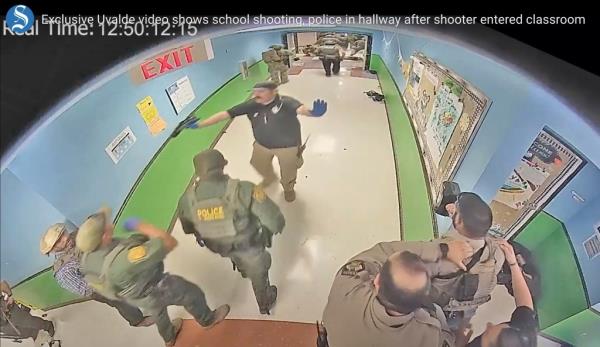 Police officers in Uvalde, Texas, were caught on video waiting outside the classroom wher<em></em>e the gunman opened fire for 70 minutes.