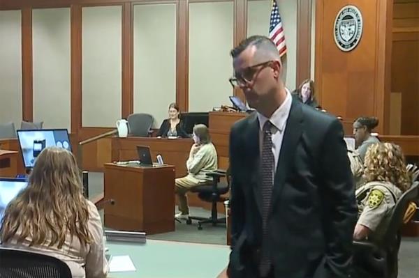 A man in a suit and tie in a courtroom