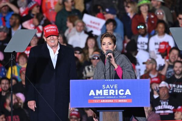 Former U.S. President Do<em></em>nald Trump listens as Sen. Marco Rubio (R-FL) speaks during a rally