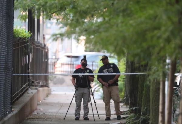 A photo of two officers recording the crime scene