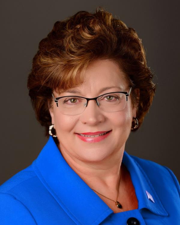 Senator Carla Nelson sitting for a headshot photo