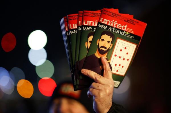 Soccer Football - Europa League - Manchester United v PAOK - Old Trafford, Manchester, Britain - November 7, 2024 A image of new Manchester United manager Ruben Amorim is seen on the cover of a fan magazine outside the stadium before the match Action Images via Reuters/Jason Cairnduff